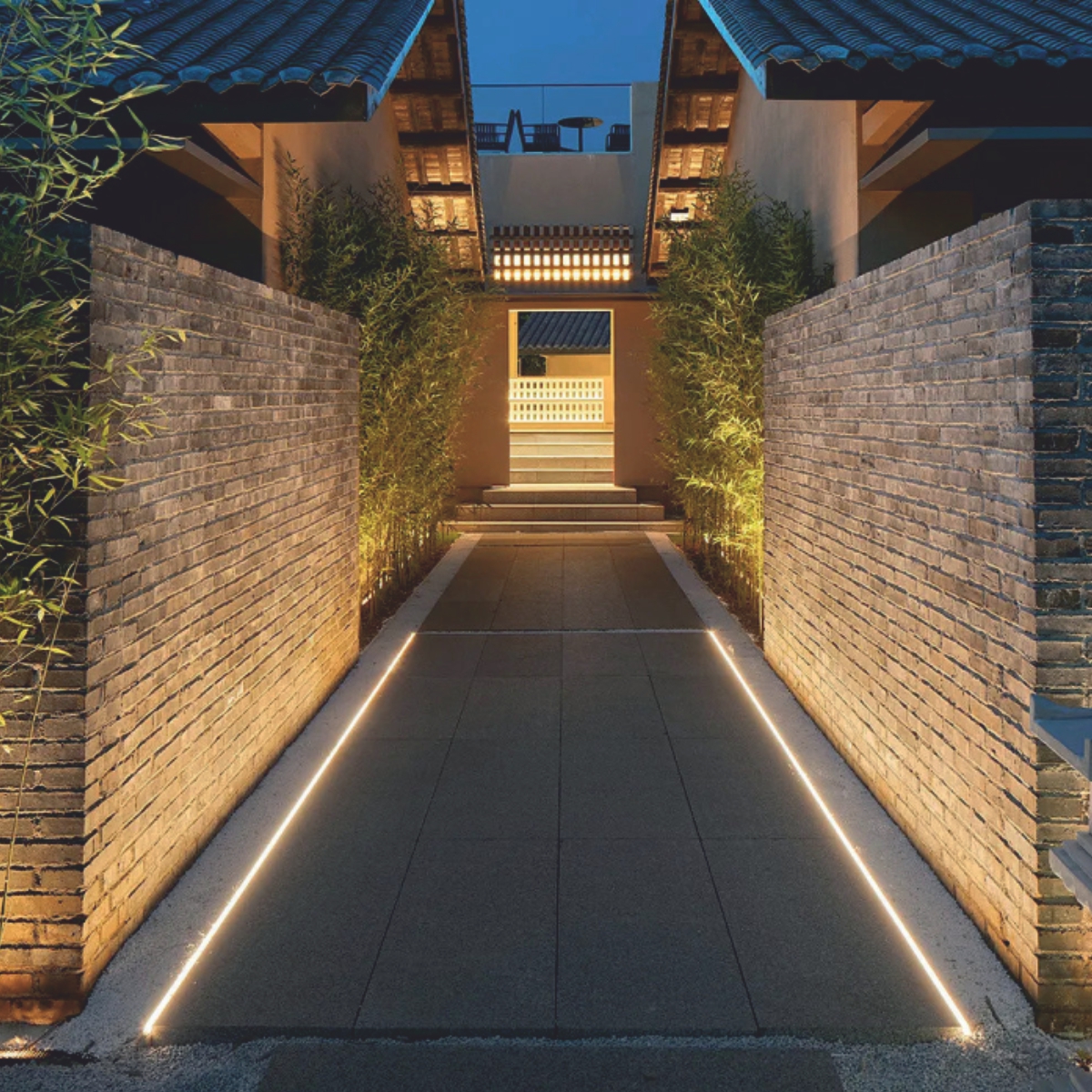 EST-SFL04AL2-1000 LED inground linear light illuminating a garden pathway.